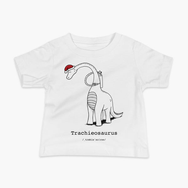 A Christmas dinosaur or trachieosaurus with a trach or tracheostomy and oxygen with a Christmas Santa hat with a stoma on a white infant t-shirt