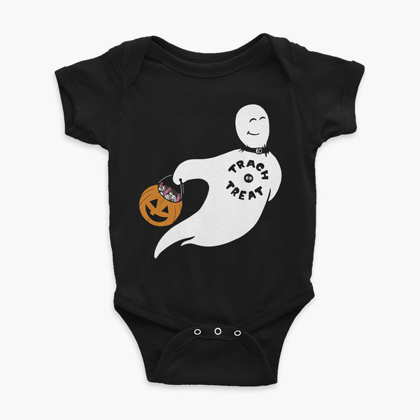 A white ghost with a trach wearing a trach or treat shirt holding a halloween bucket of trachs and saline on a black infant onesie t-shirt