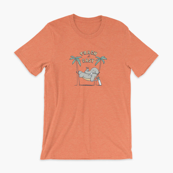 An elephant with a trach or tracheostomy and connected to an oxygen tank sits in a hammock between two palm trees with his nose around a drink just trachin’ it easy and relaxing on a heather orange adult t-shirt