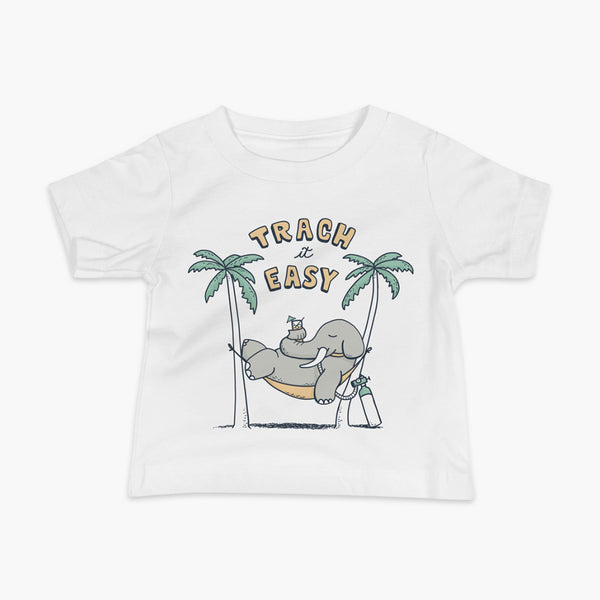 An elephant with a trach or tracheostomy and connected to an oxygen tank sits in a hammock between two palm trees with his nose around a drink just trachin’ it easy and relaxing on a white infant t-shirt