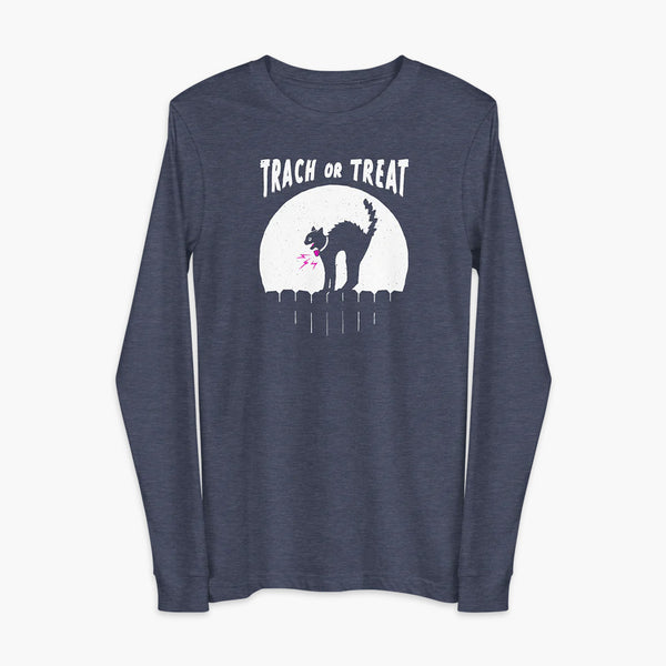 A white cat with a trach or tracheostomy and a PMV or Passy Muir valve with the word "TRACH OR TREAT" in white letter across the chest. The black cat is standing on top of a fence, silhouetted by the moon for Halloween. It is on a black heather navy adult long sleeve shirt.