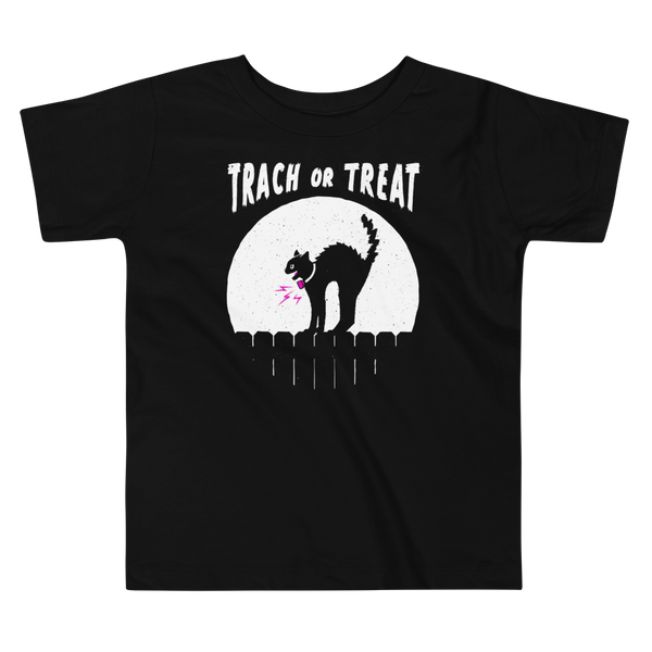 A white cat with a trach or tracheostomy and a PMV or Passy Muir valve with the word "TRACH OR TREAT" in white letter across the chest. The black cat is standing on top of a fence, silhouetted by the moon for Halloween. It is on a black kids t-shirt.