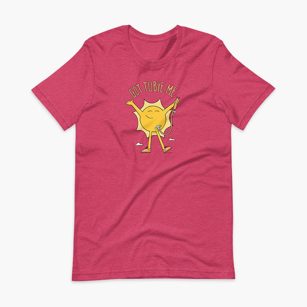 A happy sun stands confidently in tennis shoes holding a g-tube or a gastronomy tube with a stoma for StomaStoma with the text Got Tubie Me above him on an adult heather raspberry t-shirt 