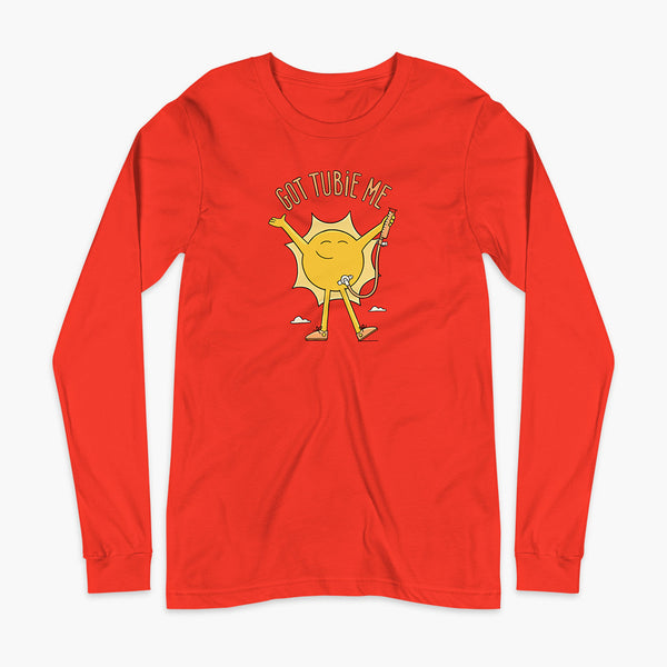 A happy sun stands confidently in tennis shoes holding a g-tube or a gastronomy tube with a stoma for StomaStoma with the text Got Tubie Me above him on an adult poppy red long sleeve t-shirt 