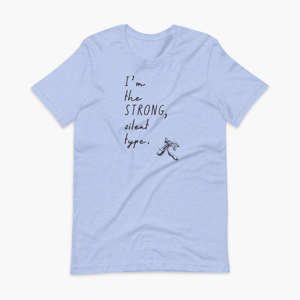 Handwritten text that say I’m the Strong Silent Type with an illustration of a trach - a bivona flextend trach with a cuff on a heather blue adult t-shirt