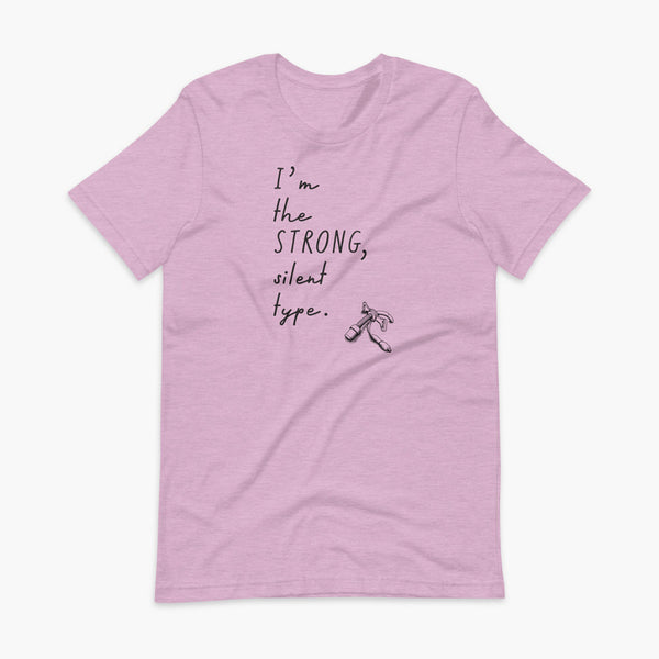 Handwritten text that say I’m the Strong Silent Type with an illustration of a trach - a bivona flextend trach with a cuff on a heather prism lilac adult t-shirt