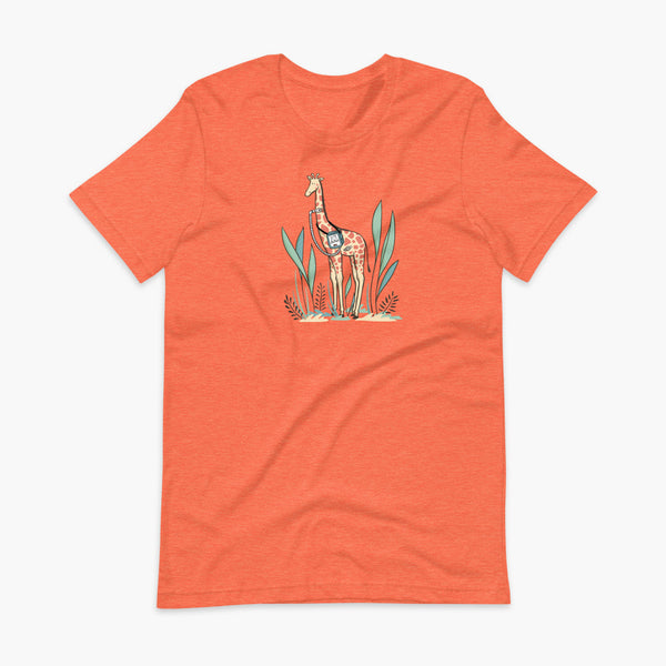 A giraffe with a trach or tracheostomy and a ventilator and g-tube mic-key button standing in a shrubbery with a stoma on a heather orange adult t-shirt