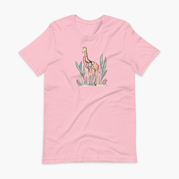 A giraffe with a trach or tracheostomy and a ventilator and g-tube mic-key button standing in a shrubbery with a stoma on a pink adult t-shirt