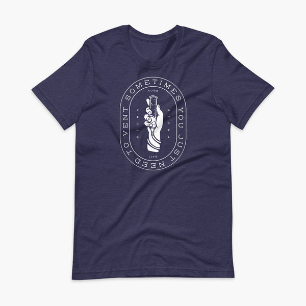 Text that says Sometimes You Just Need To Vent wrapping around a hand holding a syringe or venting tube that is connected to a g-tube or gastronomy tube and mic-key button. There is additional text that says StomaStoma and Tube Life. On a heather midnight navy adult t-shirt.