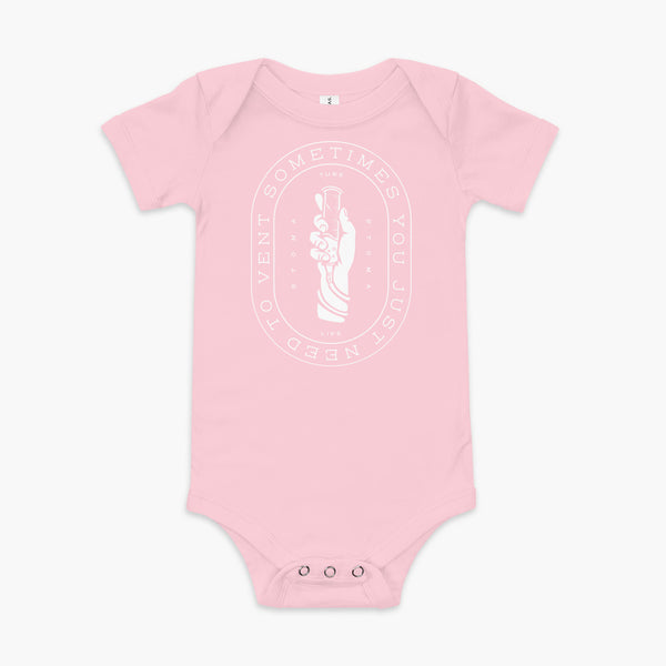 Text that says Sometimes You Just Need To Vent wrapping around a hand holding a syringe or venting tube that is connected to a g-tube or gastronomy tube and mic-key button. There is additional text that says StomaStoma and Tube Life. On a pink  infant onesie