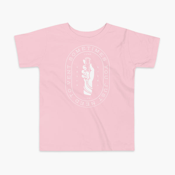 Text that says Sometimes You Just Need To Vent wrapping around a hand holding a syringe or venting tube that is connected to a g-tube or gastronomy tube and mic-key button. There is additional text that says StomaStoma and Tube Life. On a pink kids t-shirt