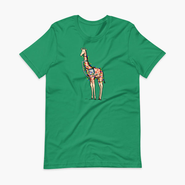 A Christmas giraffe with a trach or tracheostomy and a ventilator and g-tube mic-key button standing in a shrubbery covered in strings of Christmas lights with a stoma on a kelly green adult t-shirt