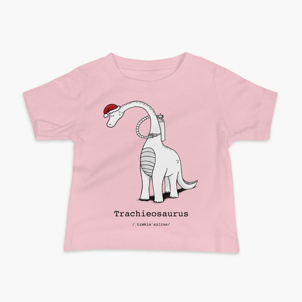 A Christmas dinosaur or trachieosaurus with a trach or tracheostomy and oxygen with a Christmas Santa hat with a stoma on a pink infant t-shirt
