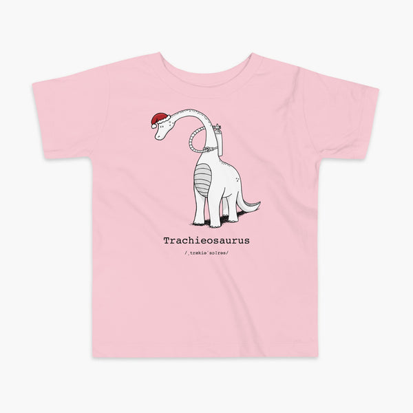 A Christmas dinosaur or trachieosaurus with a trach or tracheostomy and oxygen with a Christmas Santa hat with a stoma on a pink kids t-shirt