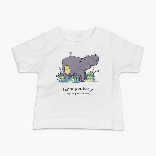 A Hippo or Hippopotamus with an ostomy bag — also known as a Hippopostomy. He is standing in some foliage smiling and has a bird on his back on a white infant t-shirt.