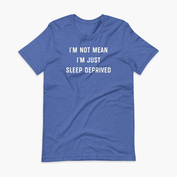Stacked white text that says I’m Not Mean I’m Just Sleep Deprived  - for living the tired tracheostomy, tubie or trach life with a stoma on a heather true royal blue adult t-shirt 