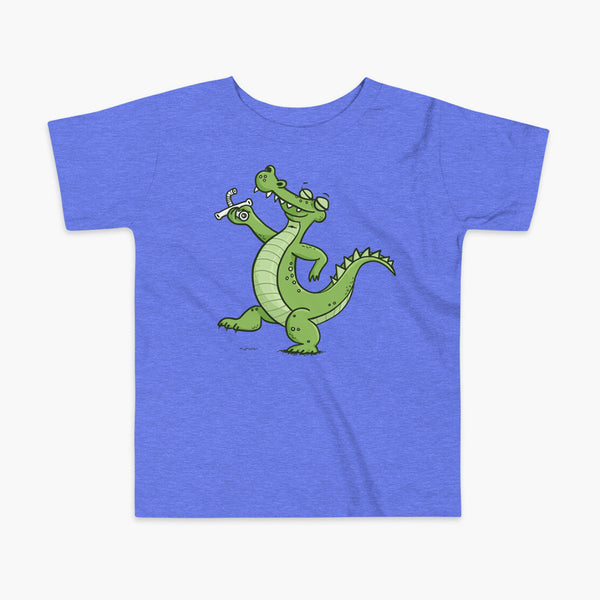 an alligator or crocodile that was decannulated or just got its trach or tracheostomy out  on a heather blue kids t-shirt