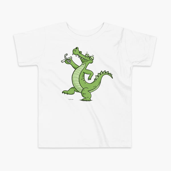 an alligator or crocodile that was decannulated or just got its trach or tracheostomy out  on a white kids t-shirt
