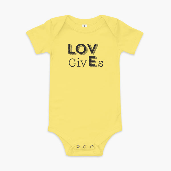 The word Love has given its “E” to the the word Gives. So it says Lov givEs on a yellow infant onesie.