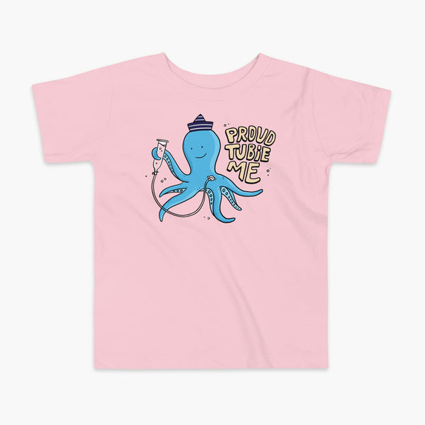 An octopus with a g-tube or gastronomy tube holding a feeding syringe doing a gravity feed in the ocean or underwater using his FreeArm feeding assistant with a stoma on a pink kids t-shirt