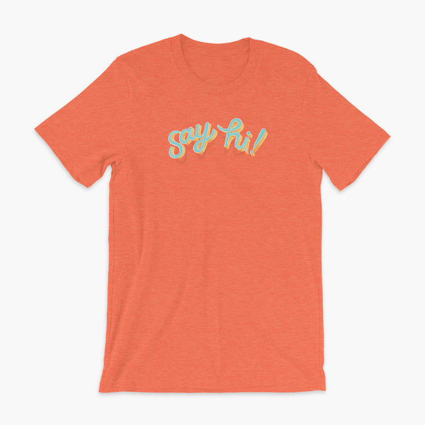 Floating say hi! script text on a heather orange adult t-shirt