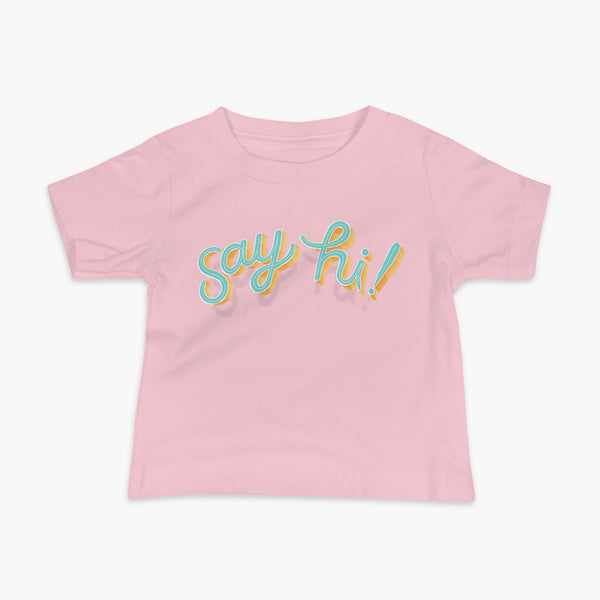Floating say hi! script text on a pink infant t-shirt