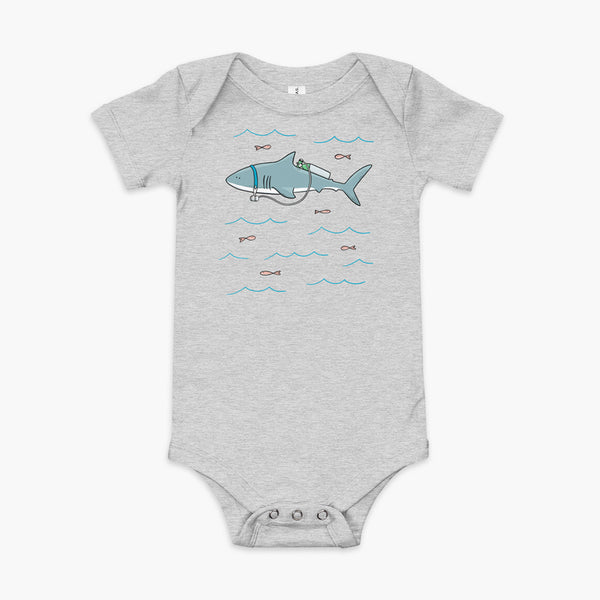 A Great White Shark with a trach or tracheostomy and tubing that goes to an oxygen or 02 tank on his back. swimming in the ocean with fish on a heather athletic infant onesie