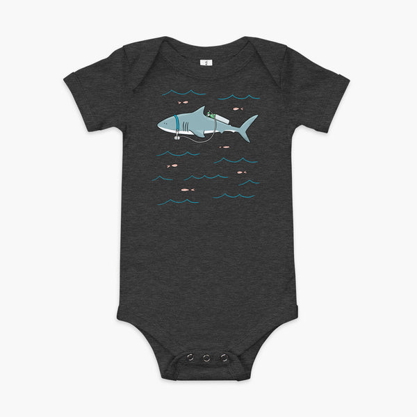 A Great White Shark with a trach or tracheostomy and tubing that goes to an oxygen or 02 tank on his back. swimming in the ocean with fish on a heather dark grey infant onesie