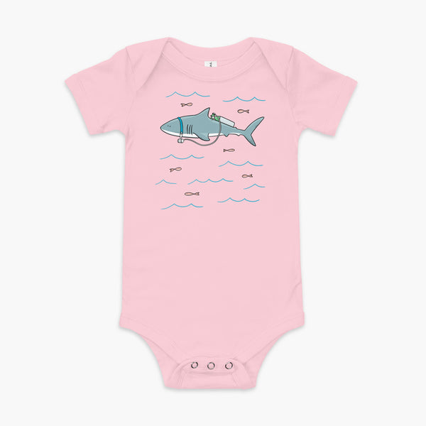 A Great White Shark with a trach or tracheostomy and tubing that goes to an oxygen or 02 tank on his back. swimming in the ocean with fish on a pink infant onesie