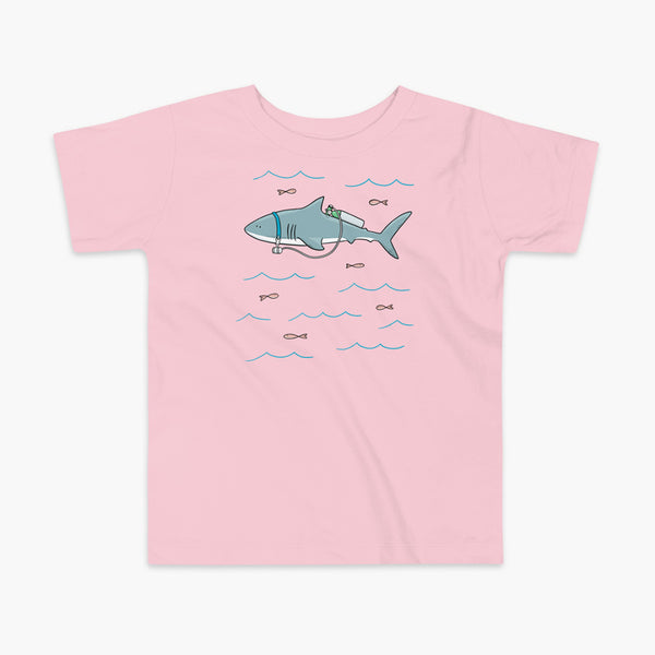 A Great White Shark with a trach or tracheostomy and tubing that goes to an oxygen or 02 tank on his back. swimming in the ocean with fish on a pink kids t-shirt