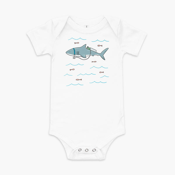 A Great White Shark with a trach or tracheostomy and tubing that goes to an oxygen or 02 tank on his back. swimming in the ocean with fish on a white infant onesie