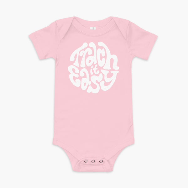 White text that says Trach It Easy for living the tracheostomy life with StomaStoma on a pink infant onesie