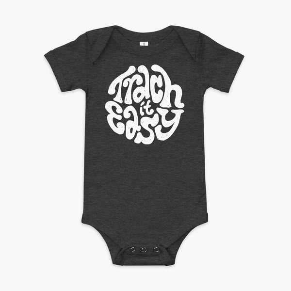 White text that says Trach It Easy for living the tracheostomy life with StomaStoma on a heather dark grey infant onesie