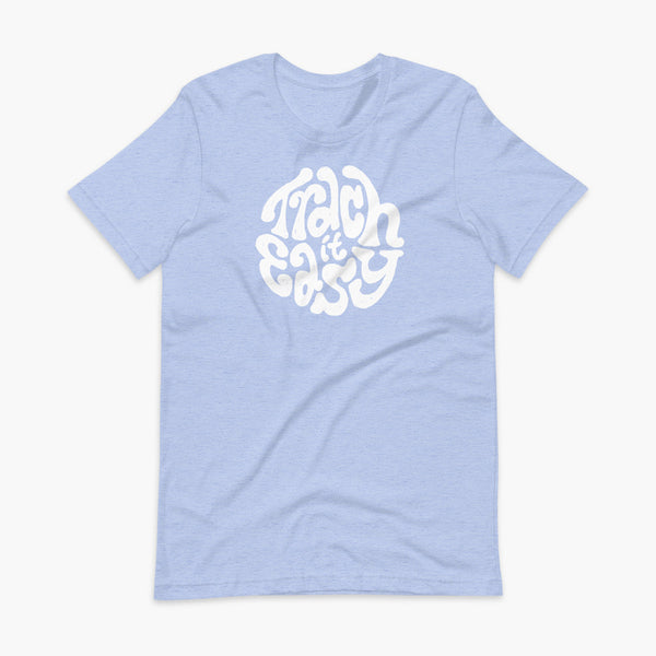 White text that says Trach It Easy for living the tracheostomy life with StomaStoma on a heather blue adult t-shirt 