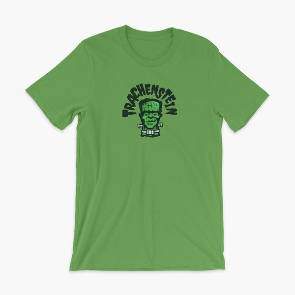A Frankenstein with a trach or tracheostomy is called a Trachenstein! He has bolts in his neck and an HME on trach in his stoma. On a leaf green adult t-shirt