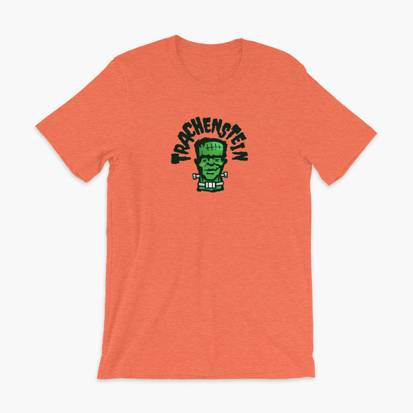 A Frankenstein with a trach or tracheostomy is called a Trachenstein! He has bolts in his neck and an HME on trach in his stoma. On a heather orange adult t-shirt