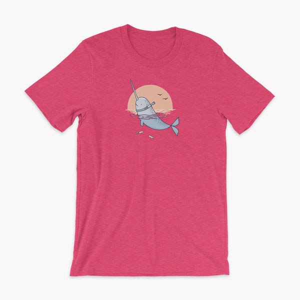 A Narwhal that has a trach or tracheostomy pokes his head and horn through the water in front of a setting sun. He has a naturally built in stoma. It is on a heather raspberry adult t-shirt.