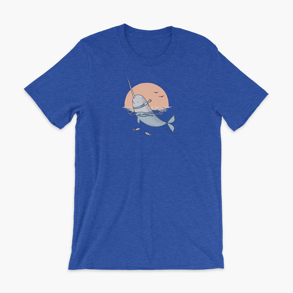 A Narwhal that has a trach or tracheostomy pokes his head and horn through the water in front of a setting sun. He has a naturally built in stoma. It is on a heather true royal adult t-shirt.