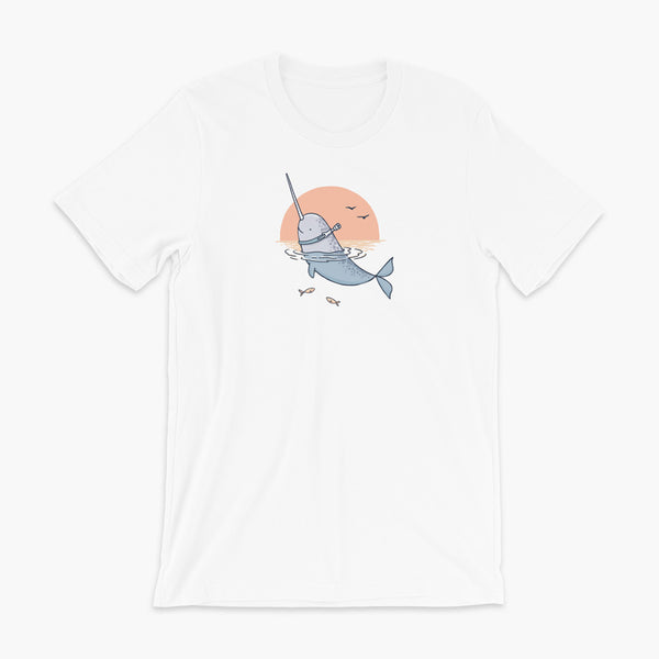 A Narwhal that has a trach or tracheostomy pokes his head and horn through the water in front of a setting sun. He has a naturally built in stoma. It is on a white adult t-shirt.