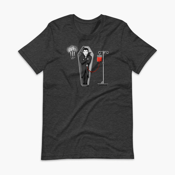 A halloween vampire is sleeping in a coffin in his castle and eating blood through a drip blood bag directly into his g-tube or gastronomy tube and g-tube mic-key a heather dark grey adult t-shirt