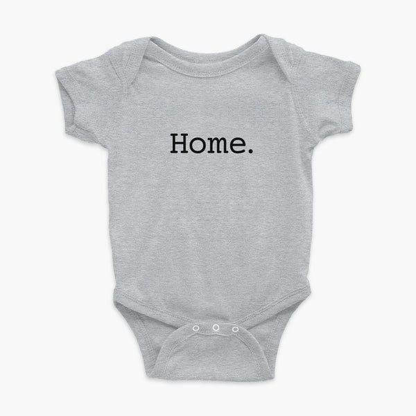 Simply the word home. On the center of the t-shirt on a heather grey onesie