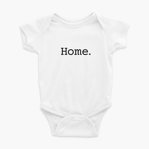 Simply the word home. On the center of the t-shirt on a white infant onesie