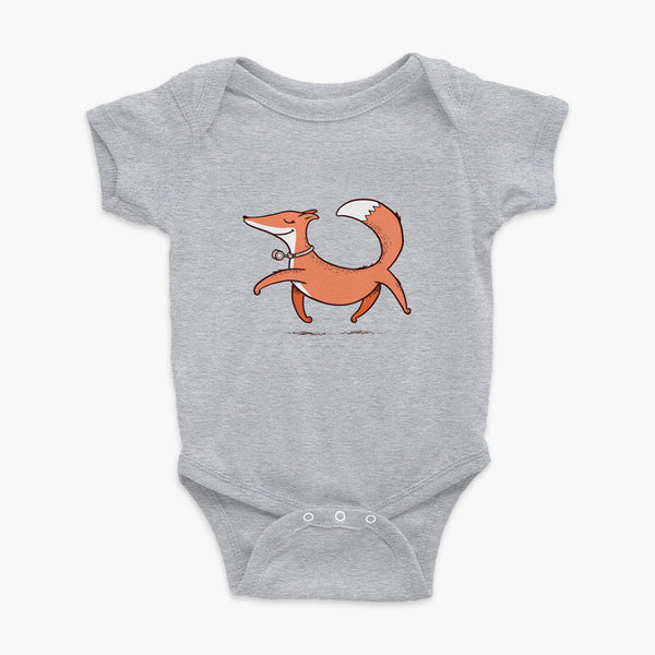 A confident orange and white fox with a trach or tracheostomy an HME for humidification trots on a heather grey infant onesie
