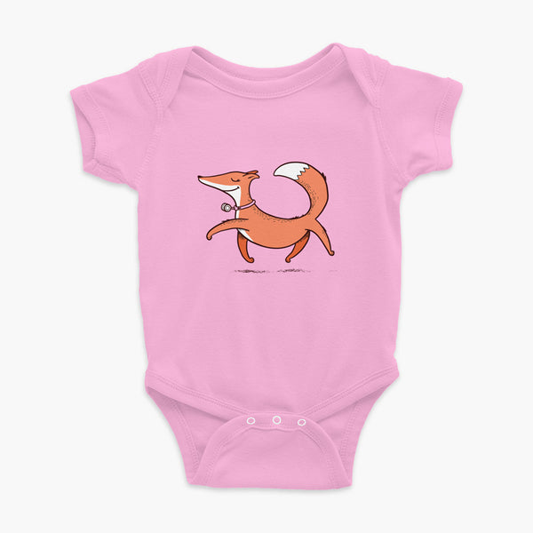 A confident orange and white fox with a trach or tracheostomy an HME for humidification trots on a pink infant onesie
