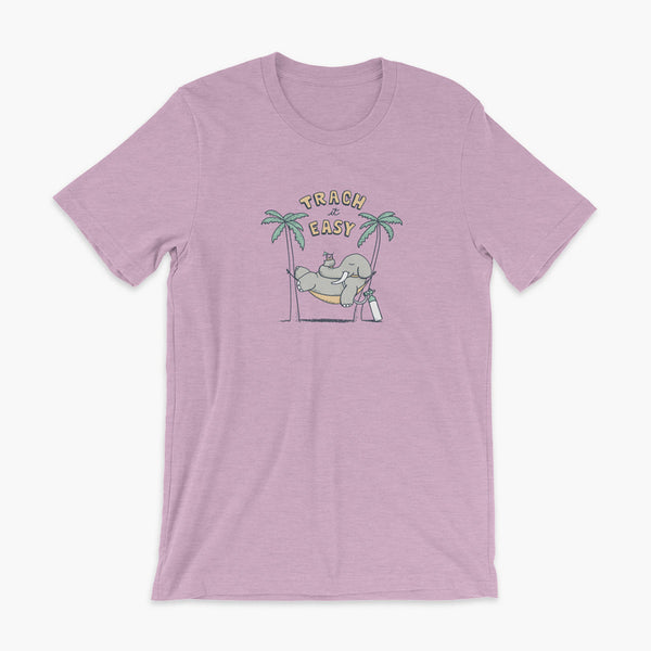 An elephant with a trach or tracheostomy and connected to an oxygen tank sits in a hammock between two palm trees with his nose around a drink just trachin’ it easy and relaxing on a heather prism lilac adult t-shirt