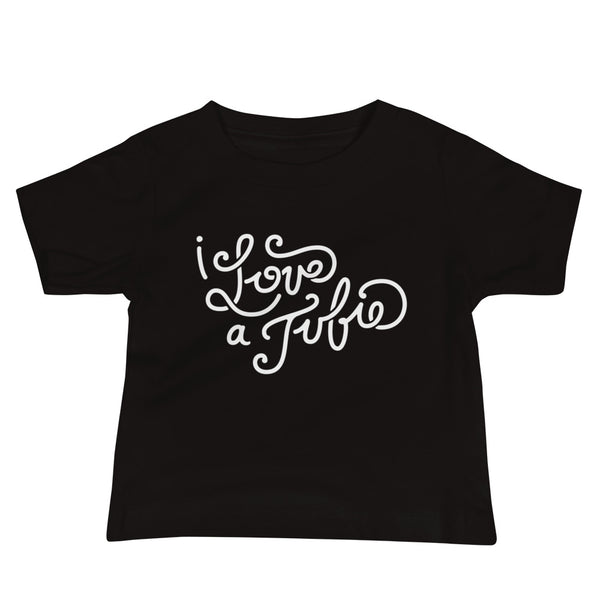 White Hand-drawn script or lettering that says I love a tubie on a  black infant t-shirt for the g-tube or stoma.