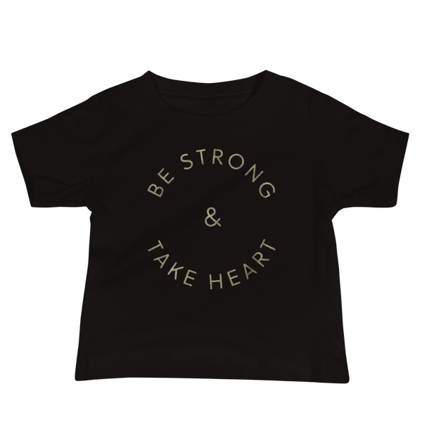 Gold text that says Be Strong & Take Heart in a circle on an infant black t-shirt by StomaStoma for g-tube and trach life empowerment.