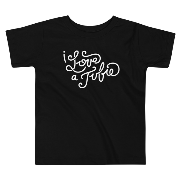 White Hand-drawn script or lettering that says I love a tubie on a black kids t-shirt for the g-tube or stoma.