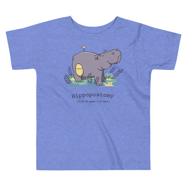 A Hippo or Hippopotamus has a stoma with an ostomy bag — also known as a Hippopostomy. He is standing in some foliage smiling and has a bird on his back on a heather columbia blue kids t-shirt.