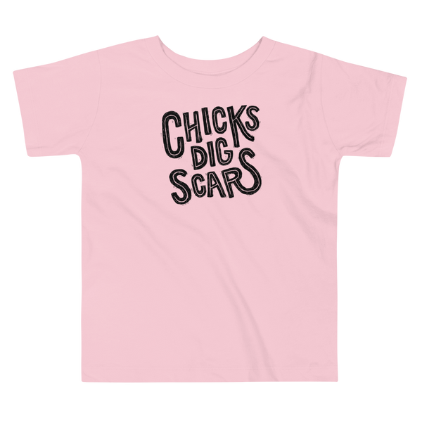 Black textured and distressed hand lettered typography that says chicks dig scars for those with a trach, g-tube or stoma on a kids Pink t-shirt